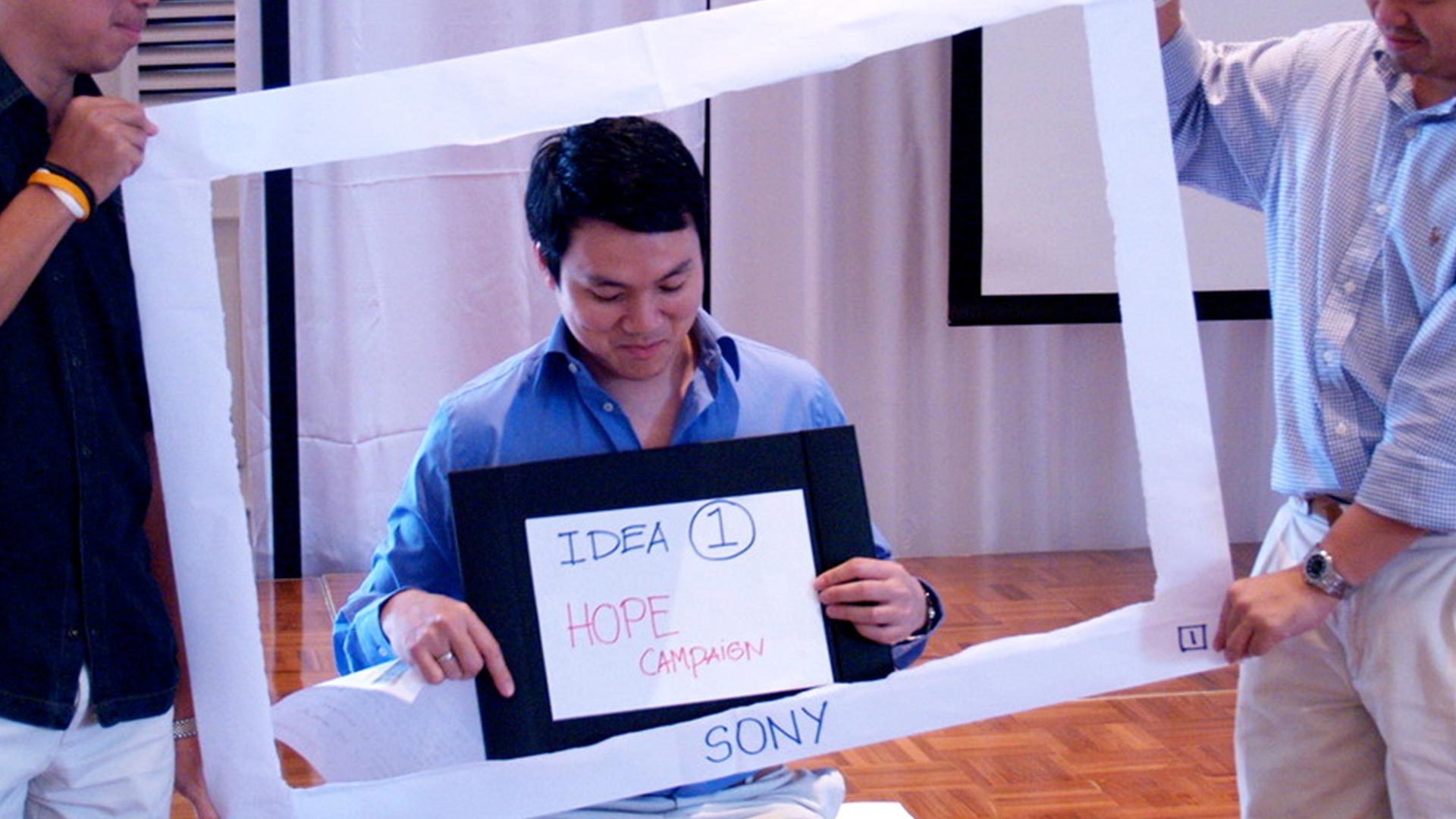 Participant holding a concept frame during the Mead Johnson workshop