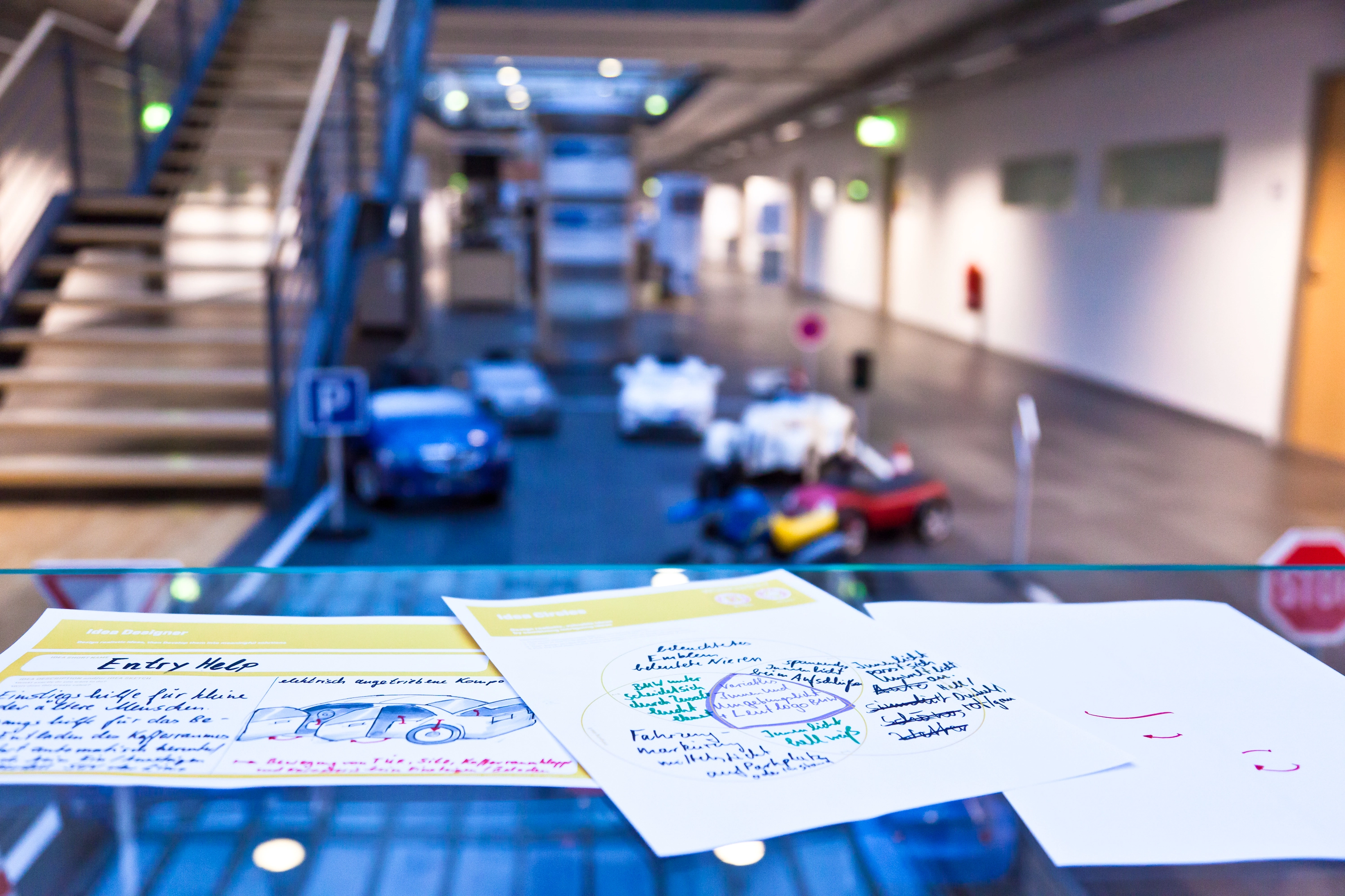 Workshop room with concept posters and model cars, BMW car interior project
