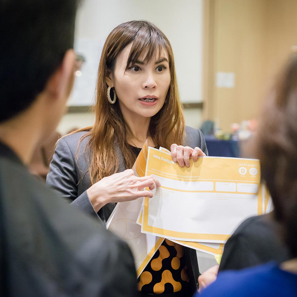 Lex presenting materials during a Thinkergy workshop