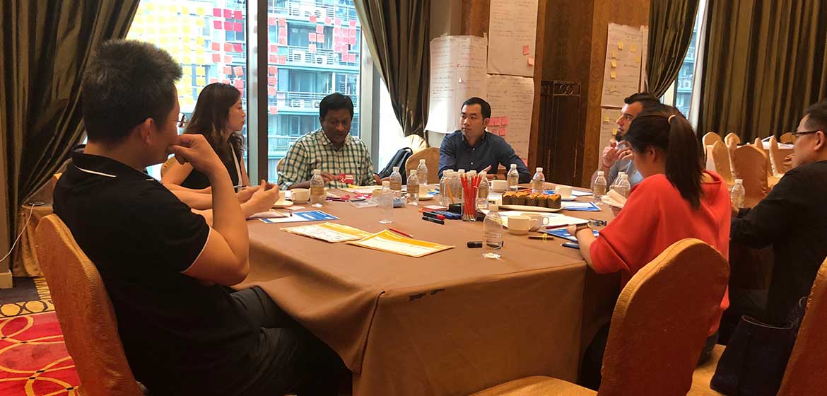 Covestro Shanghai team working at a round table with markers and worksheets