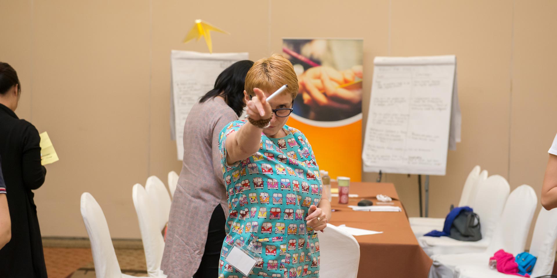 UNICEF participant throwing a paper plane in the workshop room