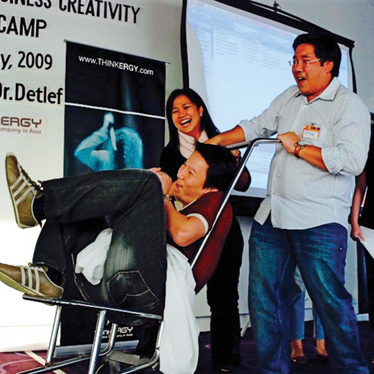 Participants performing a playful skit on stage at the Kimberly-Clark creativity bootcamp