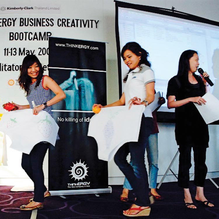 Participants presenting product ideas on stage at the Kimberly-Clark business creativity bootcamp