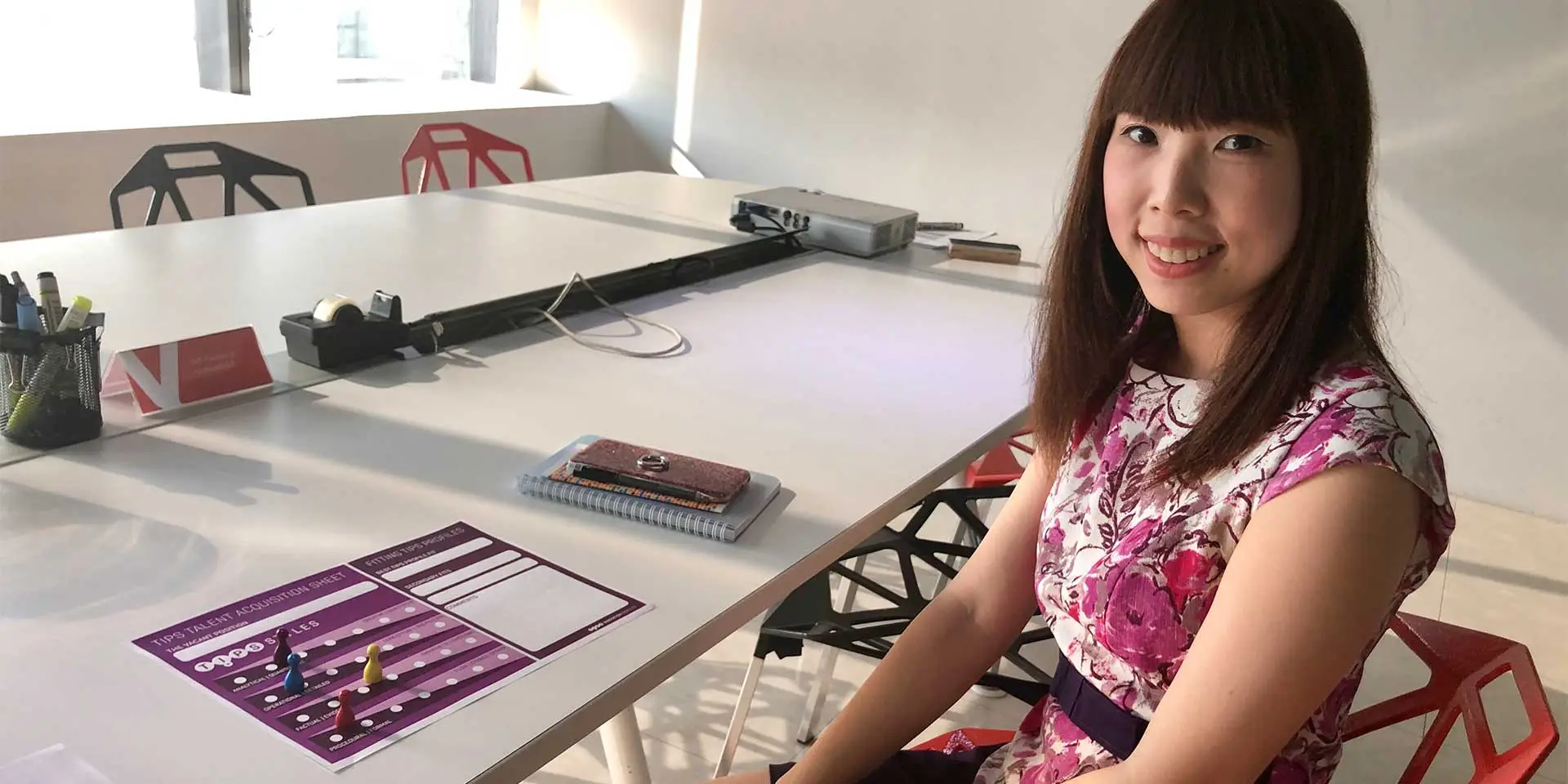 Viva Creative Studio team member at a table with a TIPS talent acquisition sheet