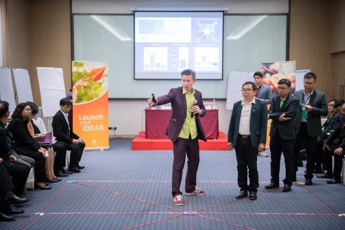 Dr. D leading a TIPS Line-Up Game with senior executives at a TRIS Academy workshop in Bangkok