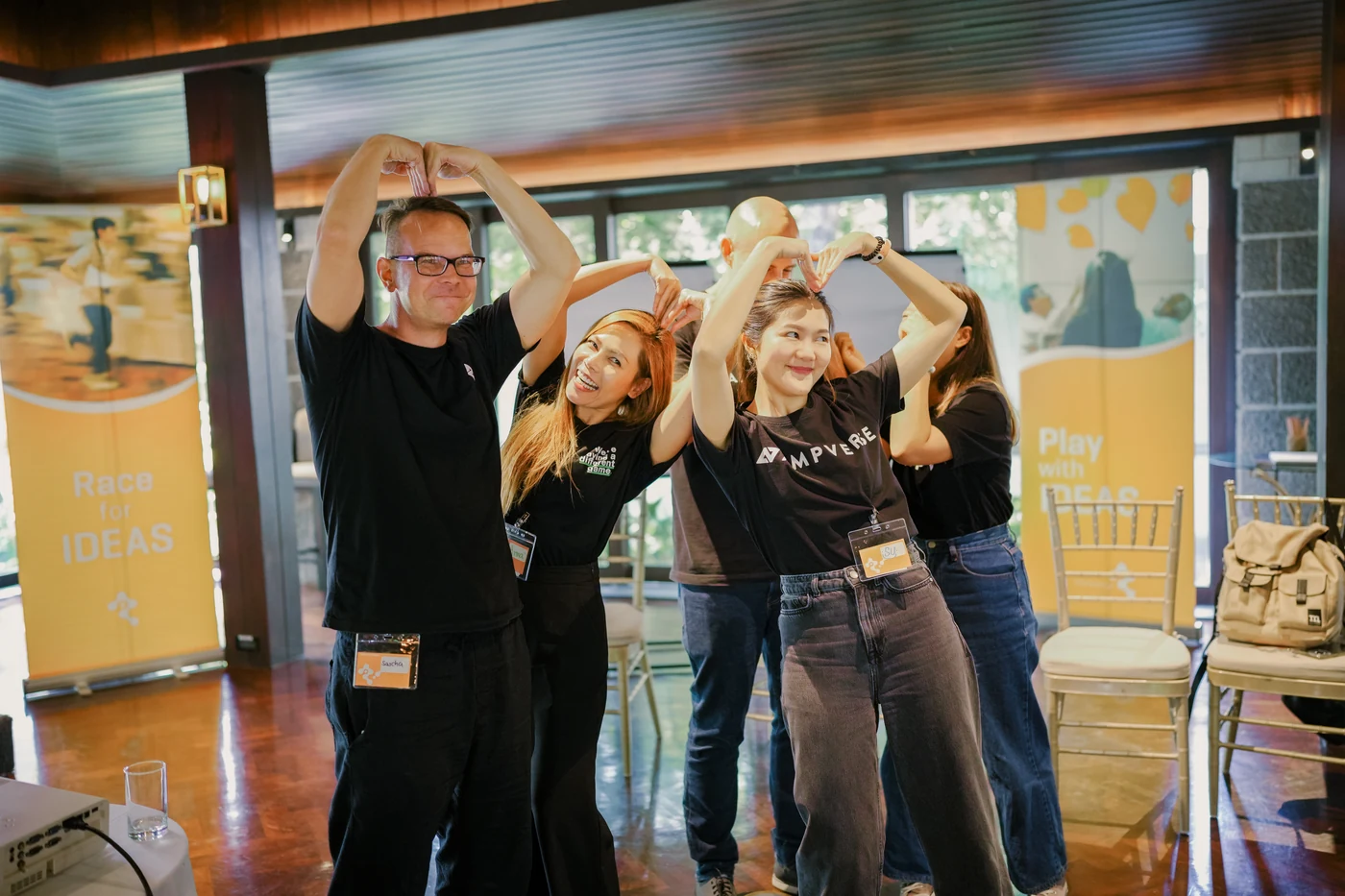 Ampverse team members forming hearts with their arms during a TIPS game