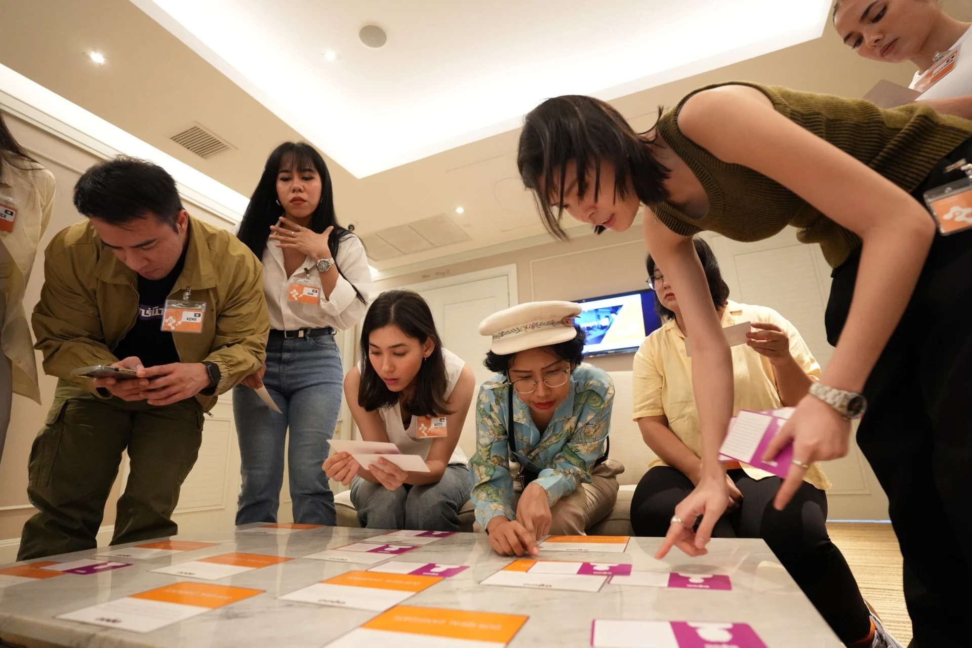 Square 44 team members sorting TIPS cards on a table during the TIPS workshop in Bangkok