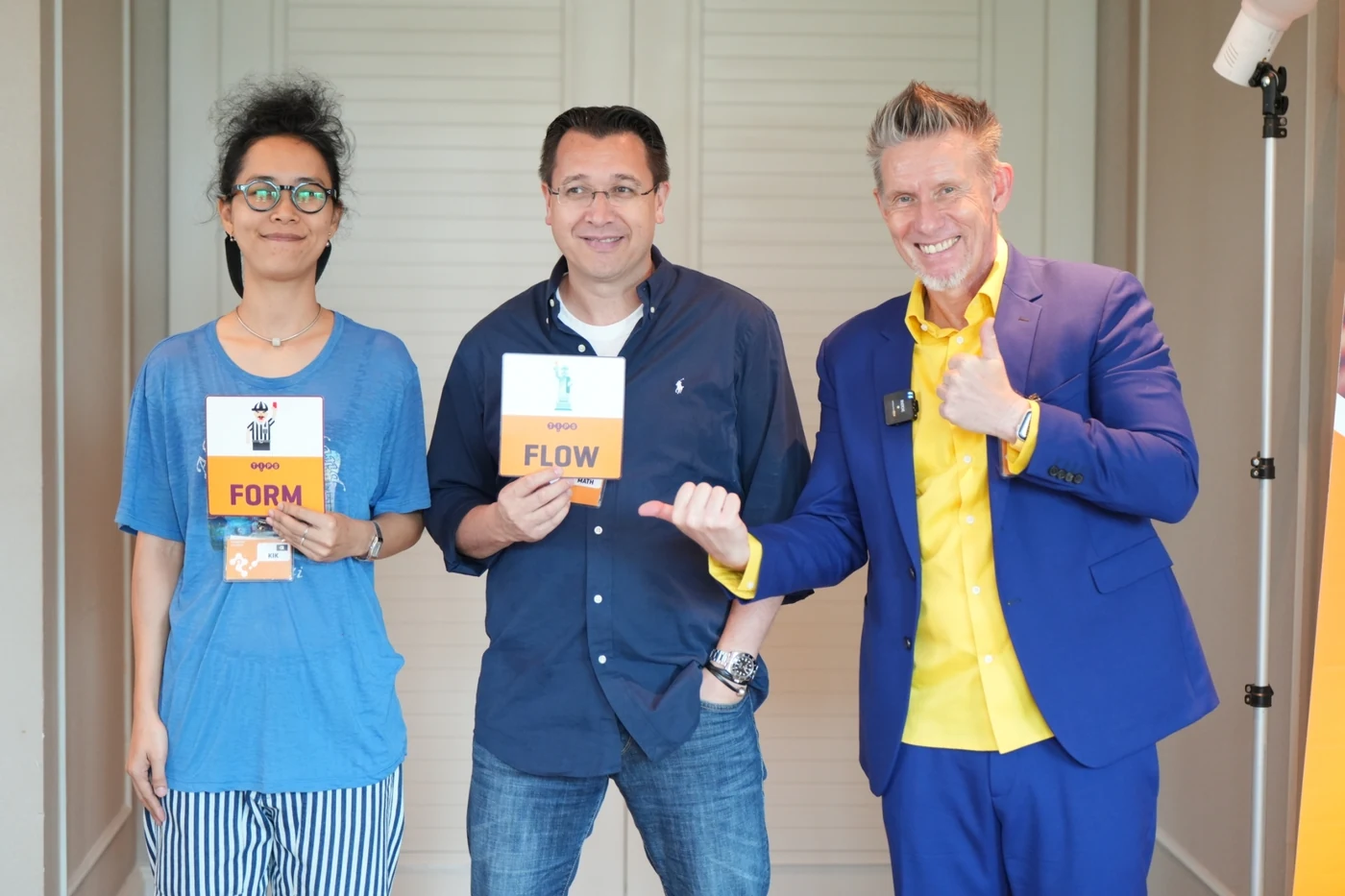Dr. D with two Square 44 participants holding up their Form and Flow cards