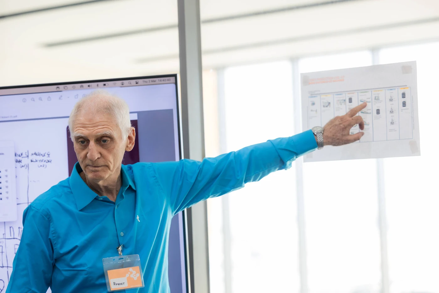 A Continental team member pointing to a worksheet during a team presentation