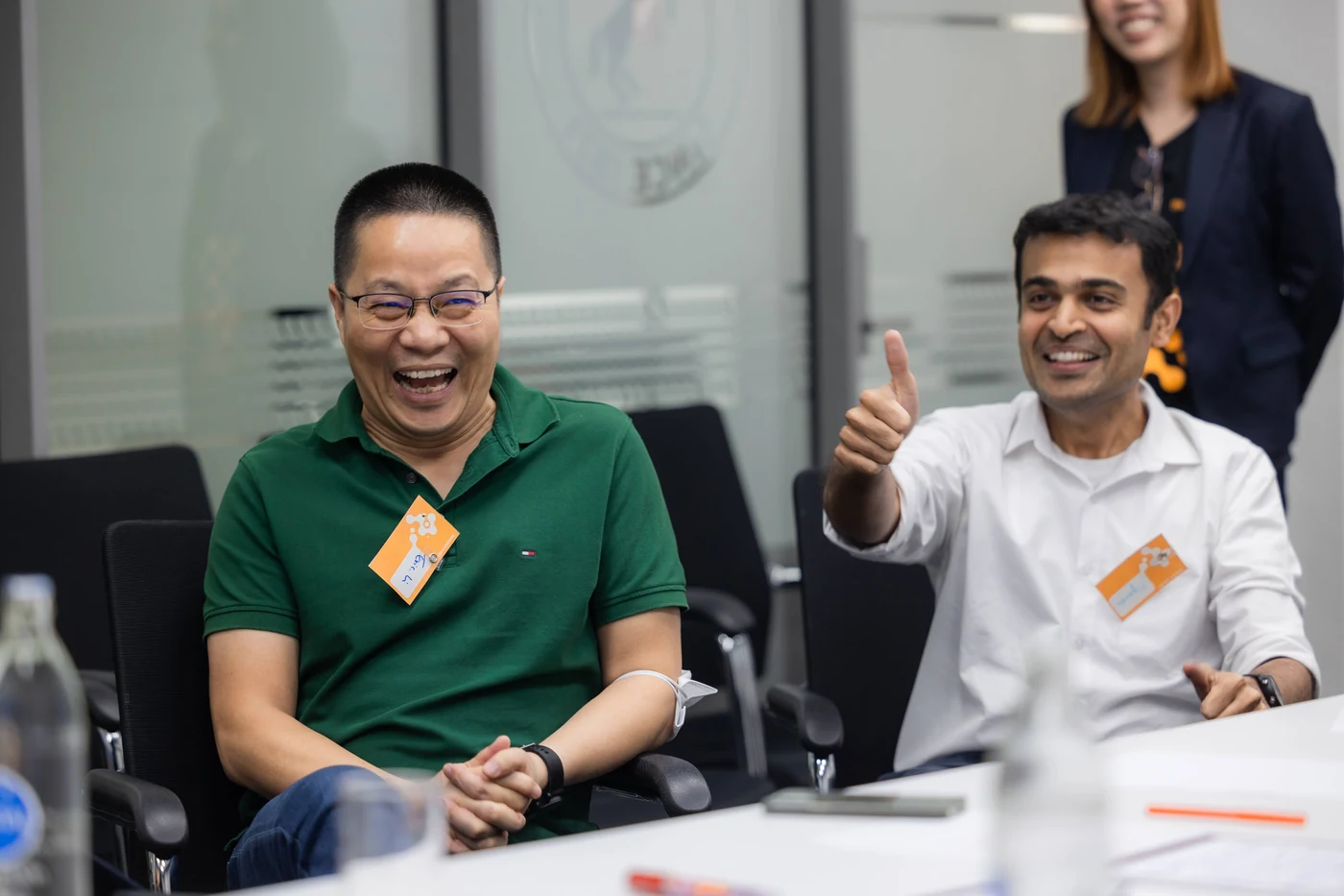 Two smiling Continental managers giving a thumbs up during the workshop