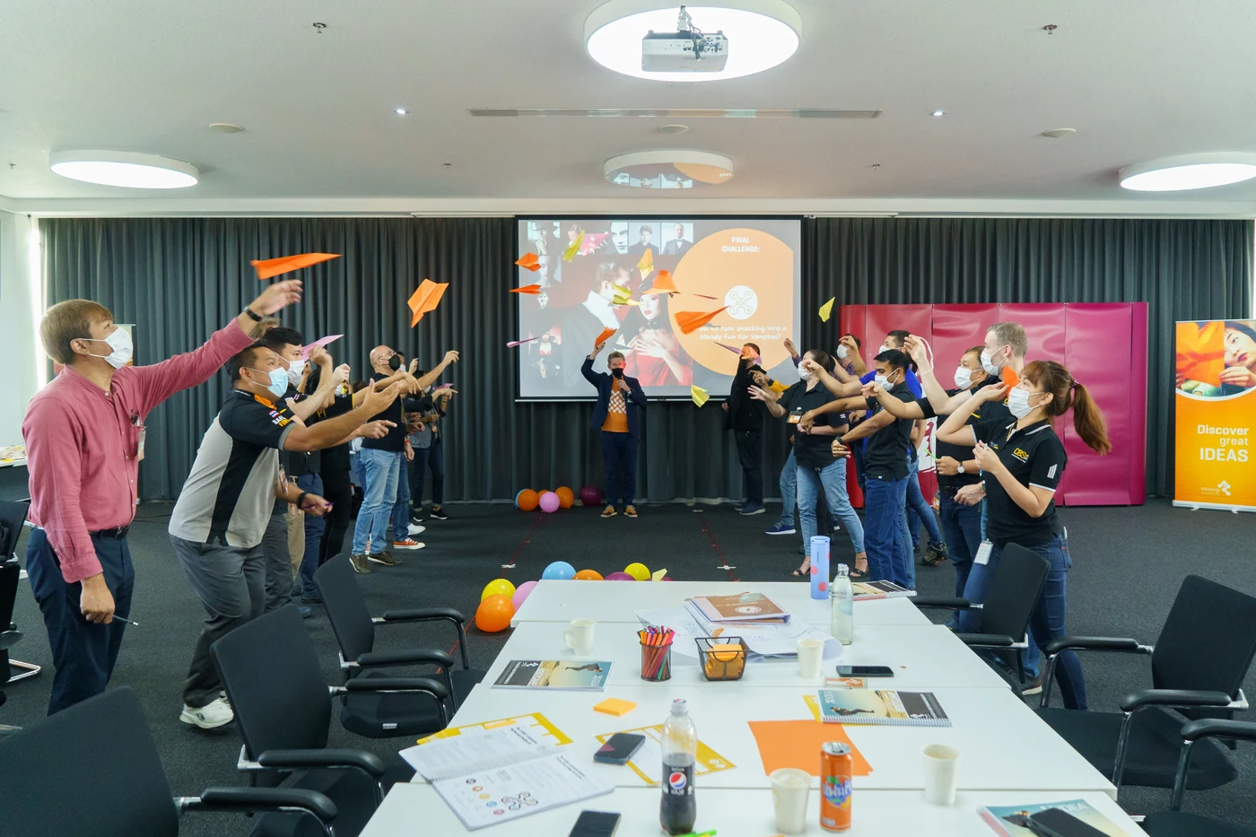 Continental Tyres Thailand managers throwing paper planes during a Thinkergy session