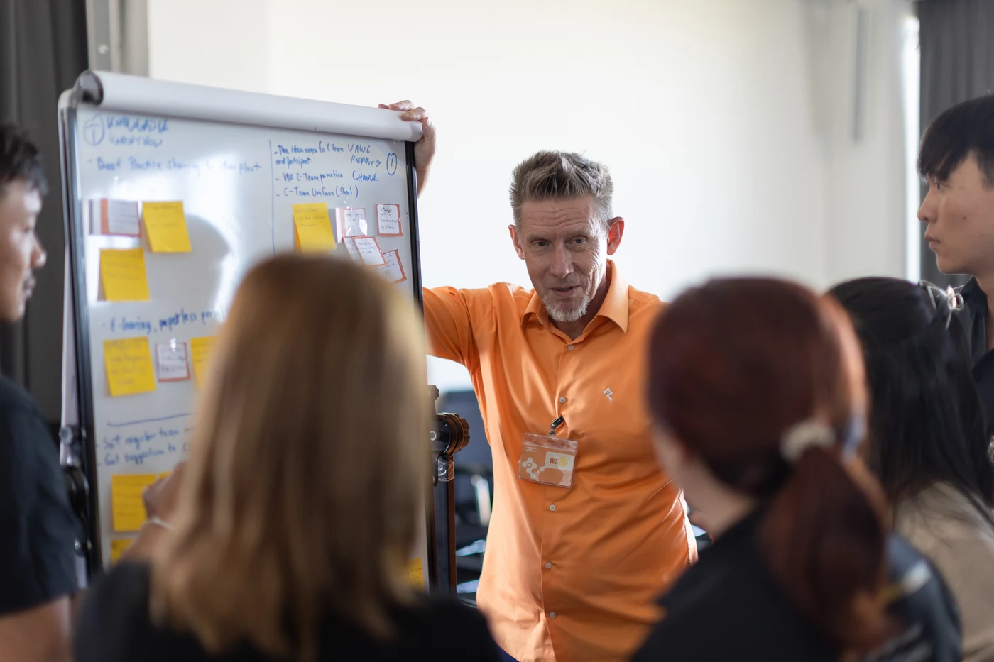 Dr. D guiding Continental participants at a flipchart during the facilitator training