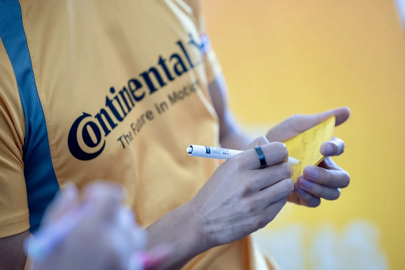 A Continental trainee writing on a sticky note