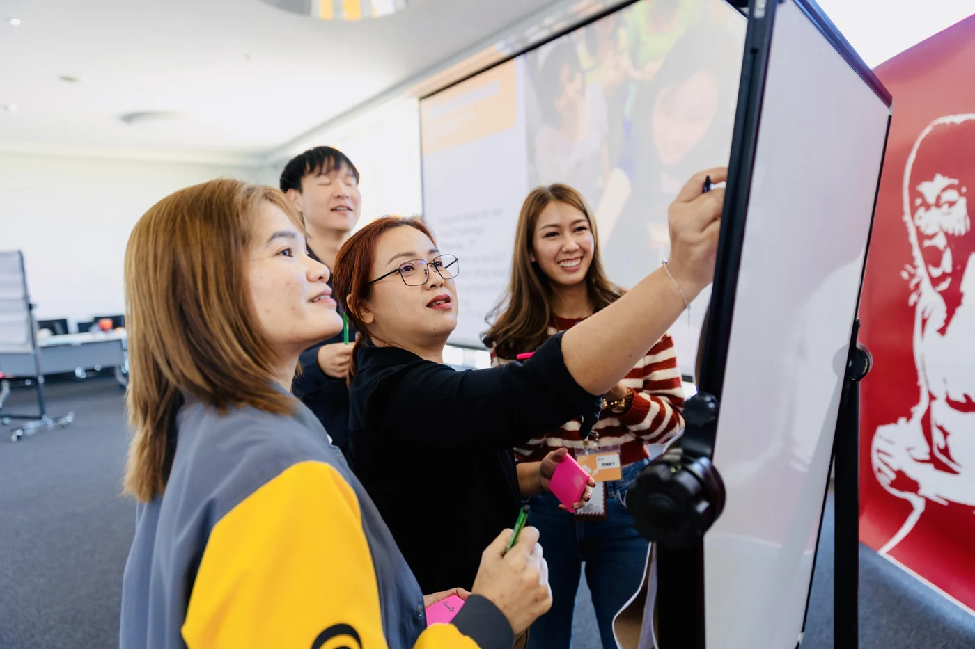 Continental facilitator trainees writing on a board together