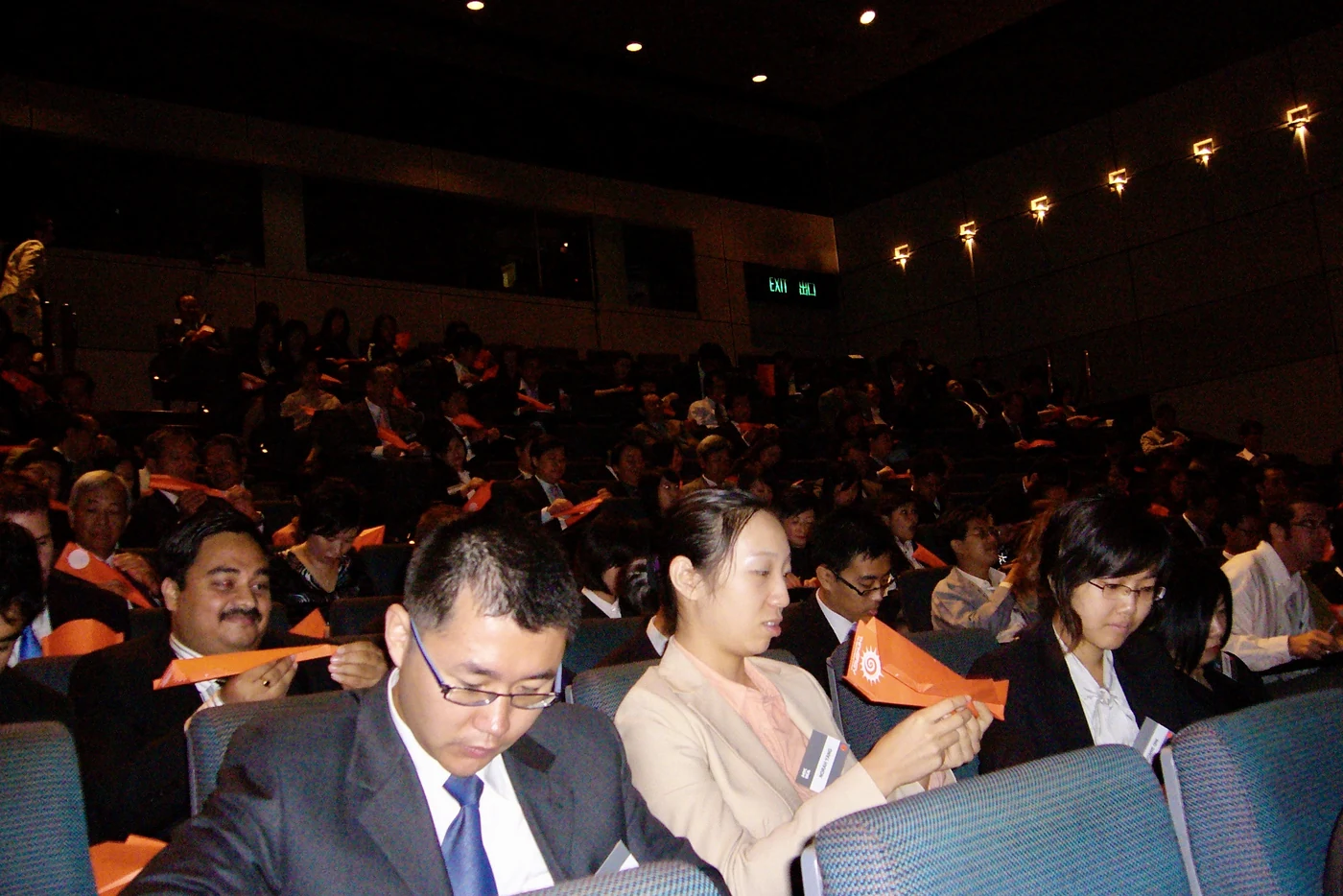 Delegates in the audience working on their paper planes