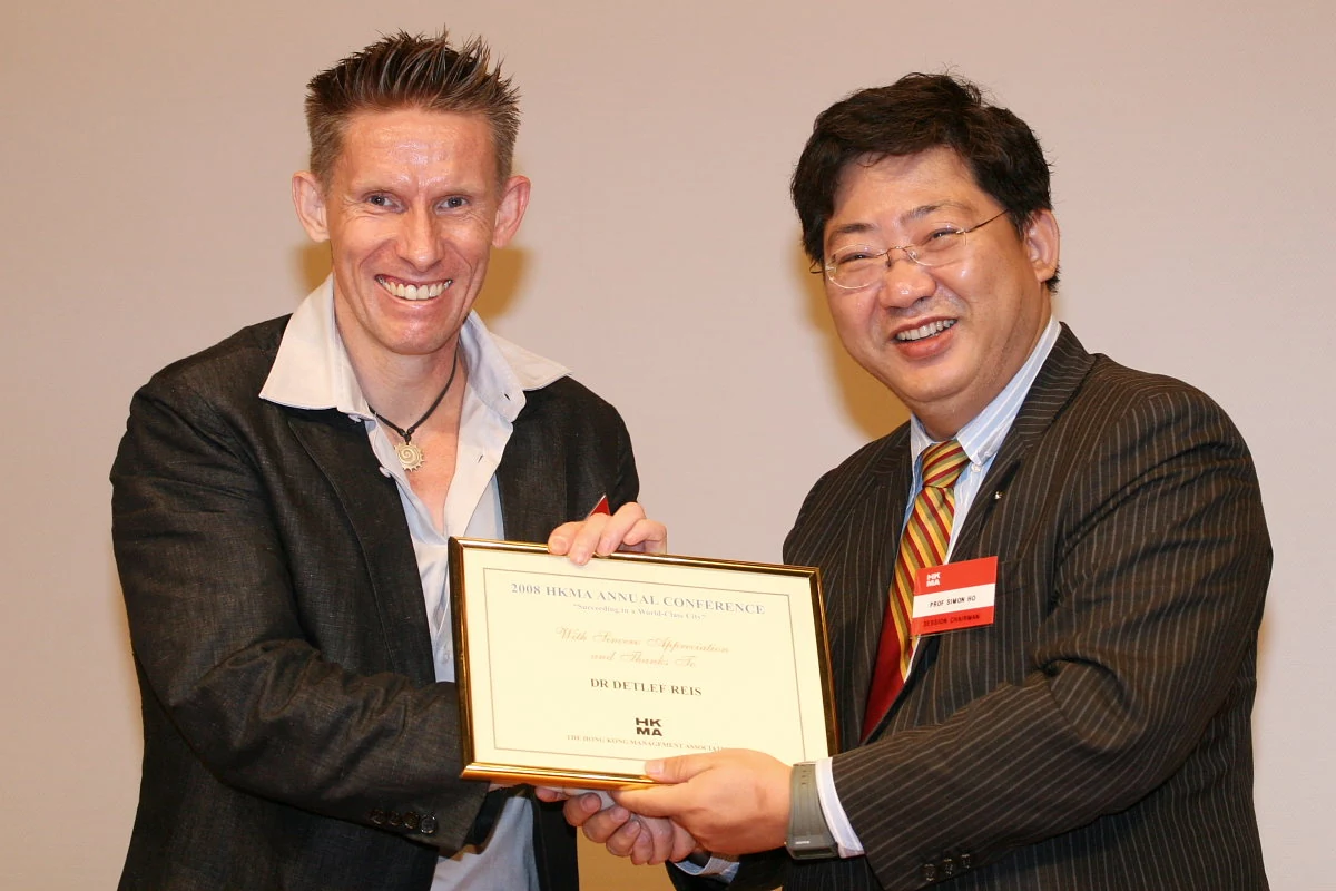 Dr. D receiving a certificate of appreciation at the HKMA conference
