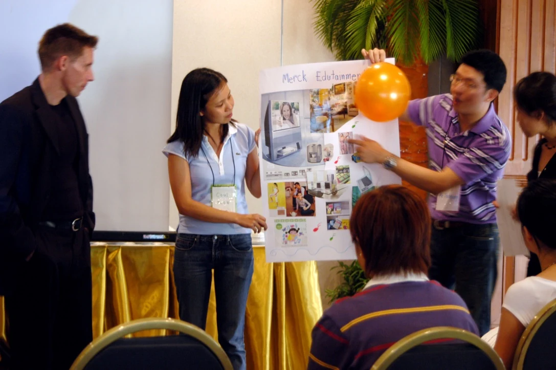 A Merck Thailand team presenting its concept poster to Dr. D