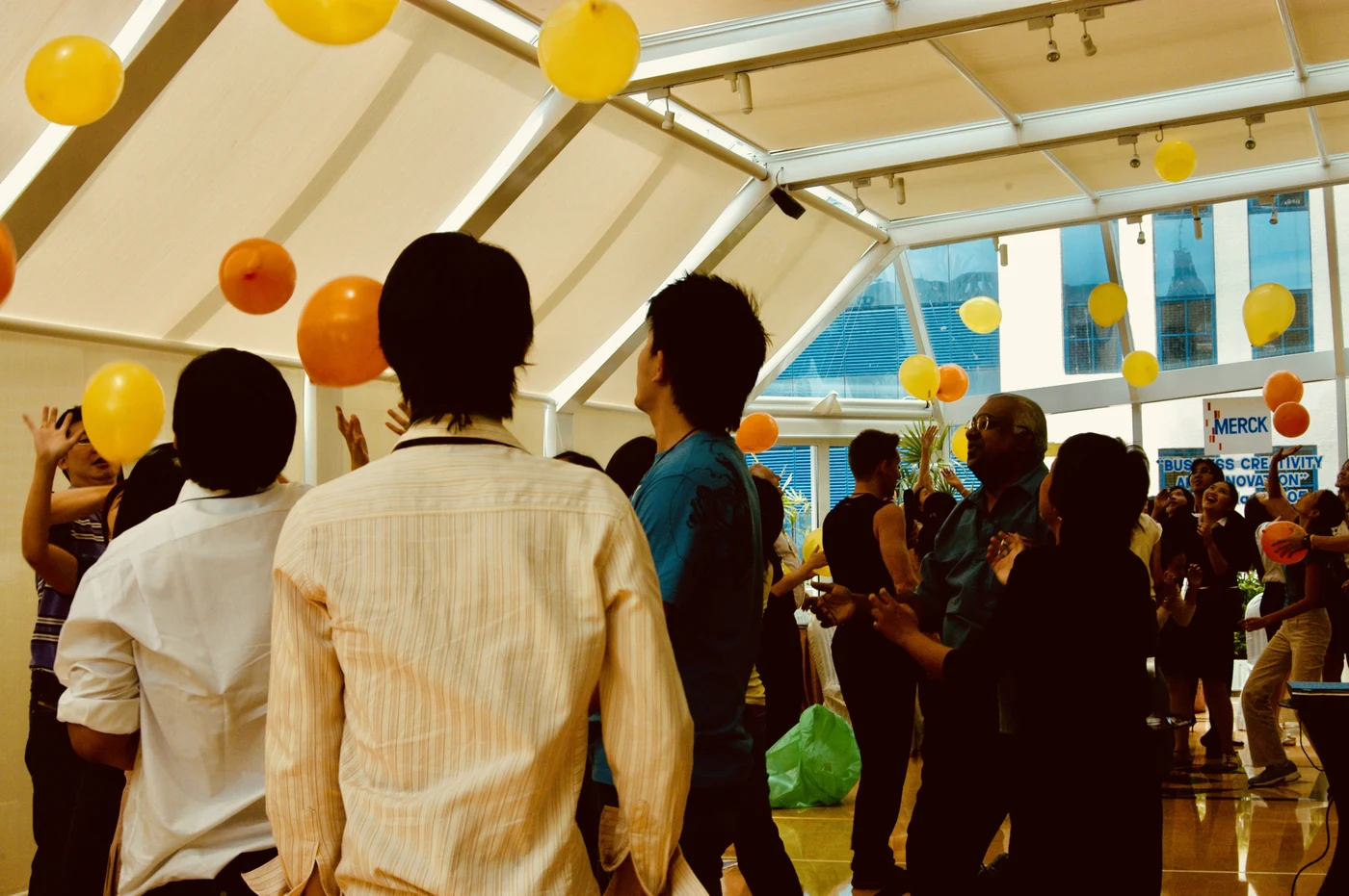 Merck Thailand team playing with balloons during an energizer