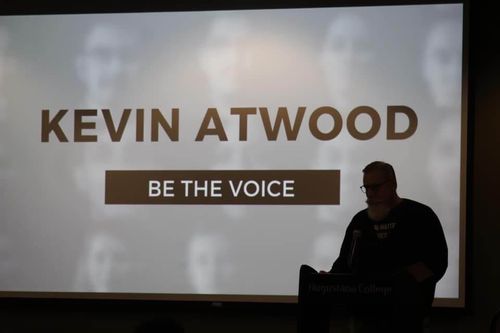 Kevin giving a presentation to a crowd.