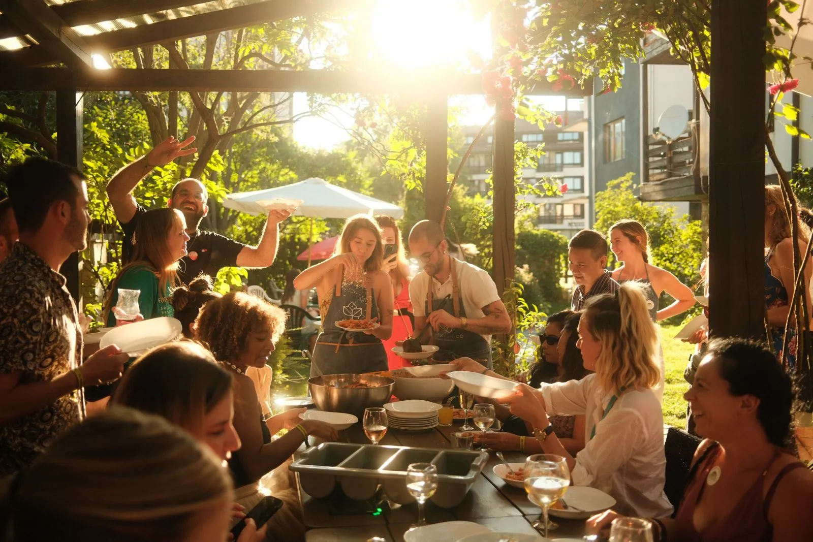 Warm dinner scene under lights with a full table of digital nomads