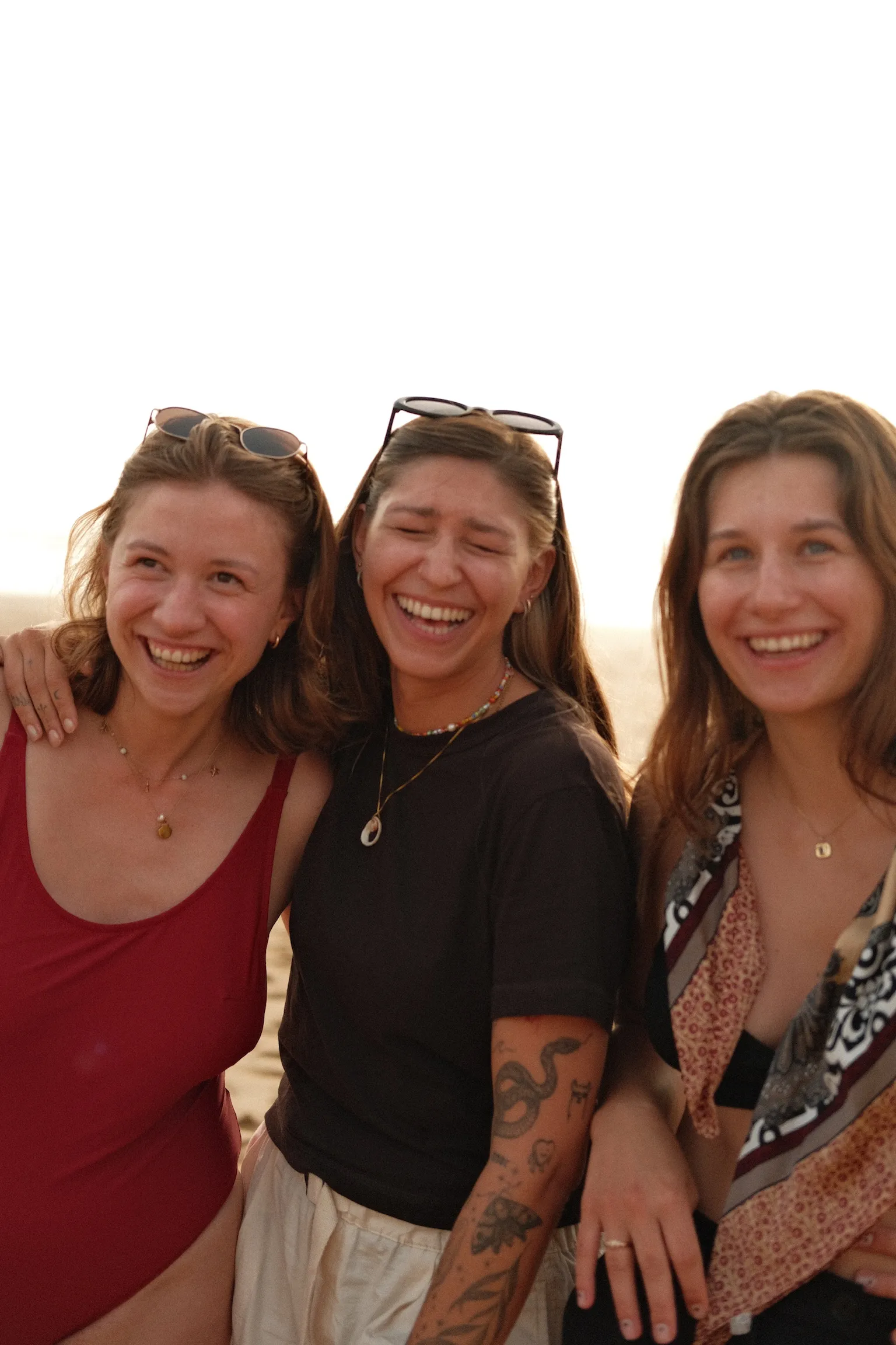 Three friends smiling during a coliving experience