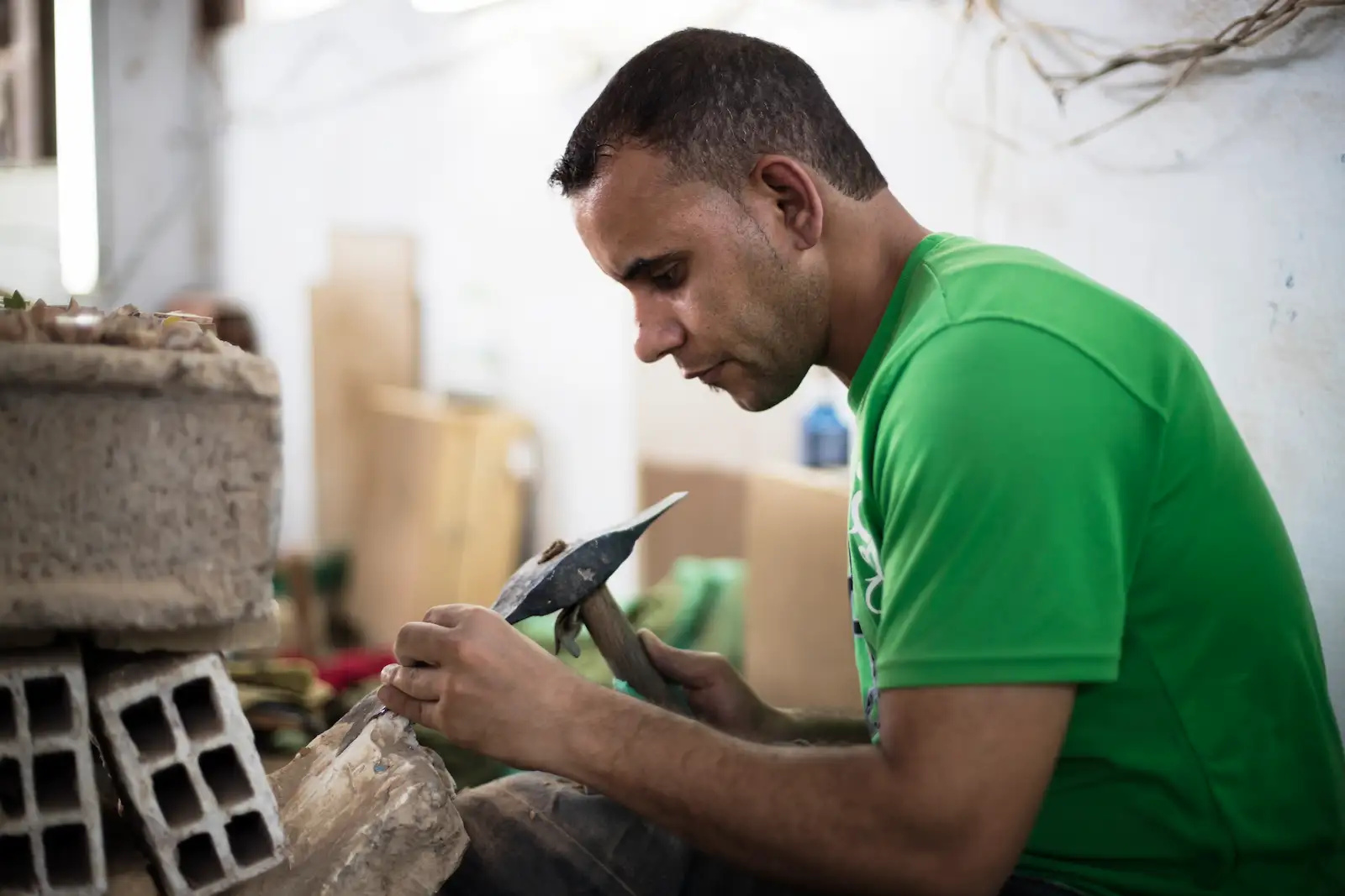 Man chiseling and building