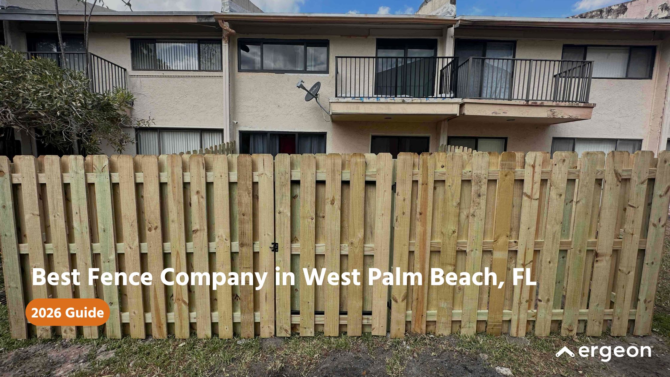 Image shows a newly installed wooden fence in front of a residential building with balconies and windows. The wooden fence is constructed of vertical planks with a small gate visible. The image contains overlaid text promoting the best fence company in West Palm Beach, FL, as per a 2026 guide, with the logo of Ergeon in the bottom right corner. This image is suitable for use in marketing or informational content related to fencing services and home improvement in the West Palm Beach area.