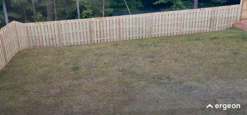 Wooden Privacy Fence Surrounding Residential Backyard Lawn