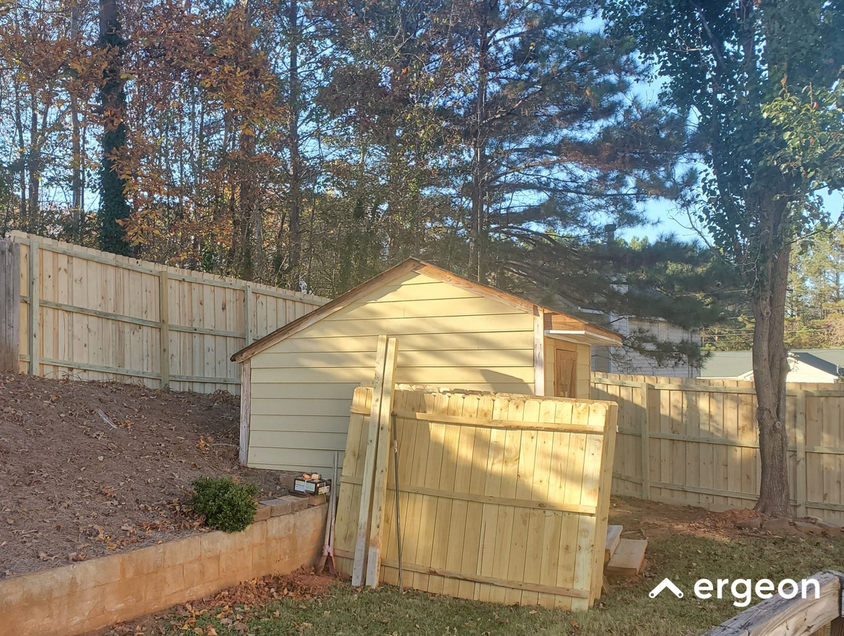 Wooden Storage Shed and Newly Installed Fence in Residential Yard
