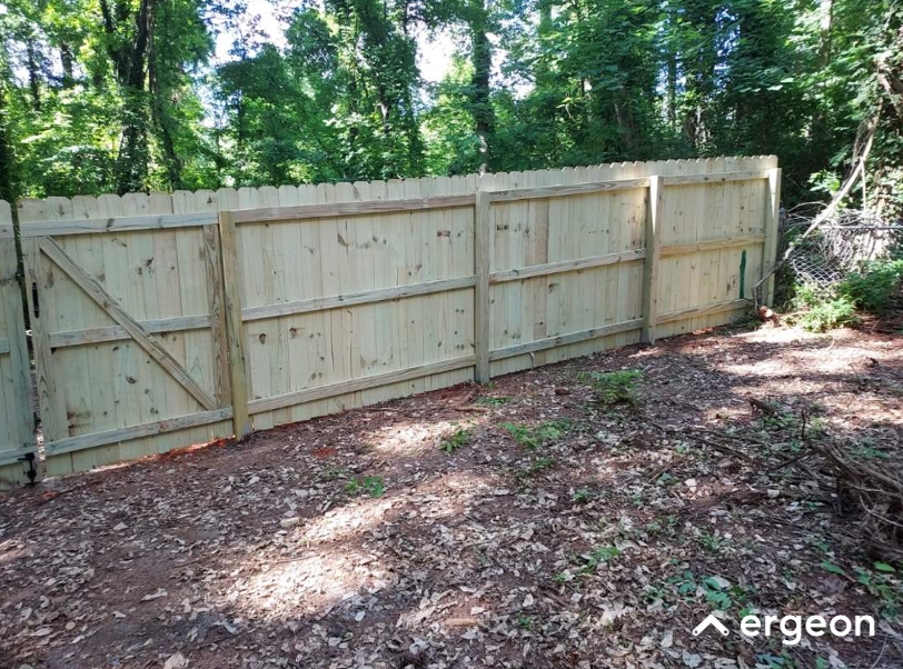 Wooden Privacy Fence Installed Along a Forested Property Line