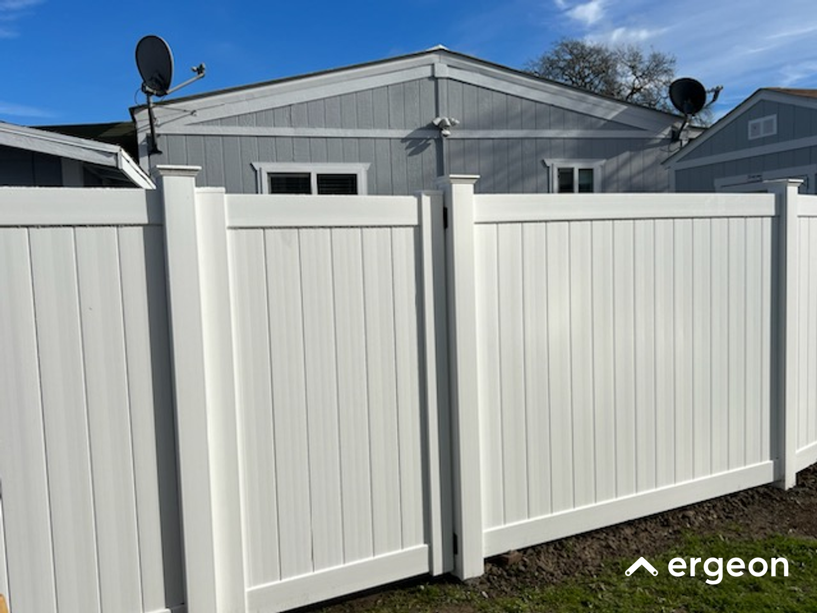 White Vinyl Privacy Fence with Gate Installed