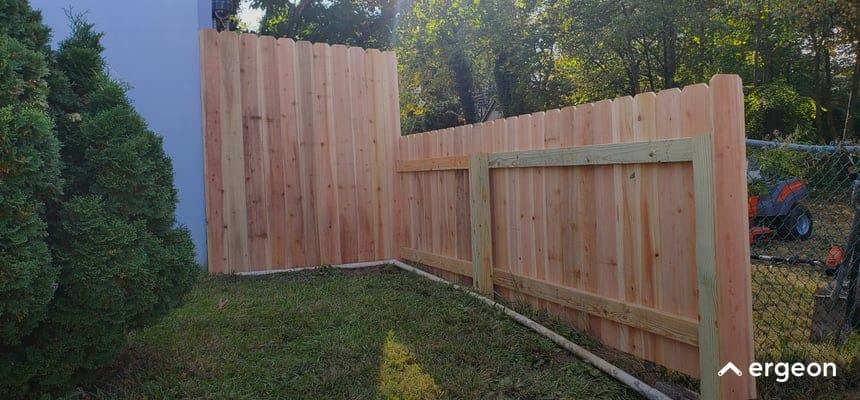 New Wooden Privacy Fence Installation in Backyard