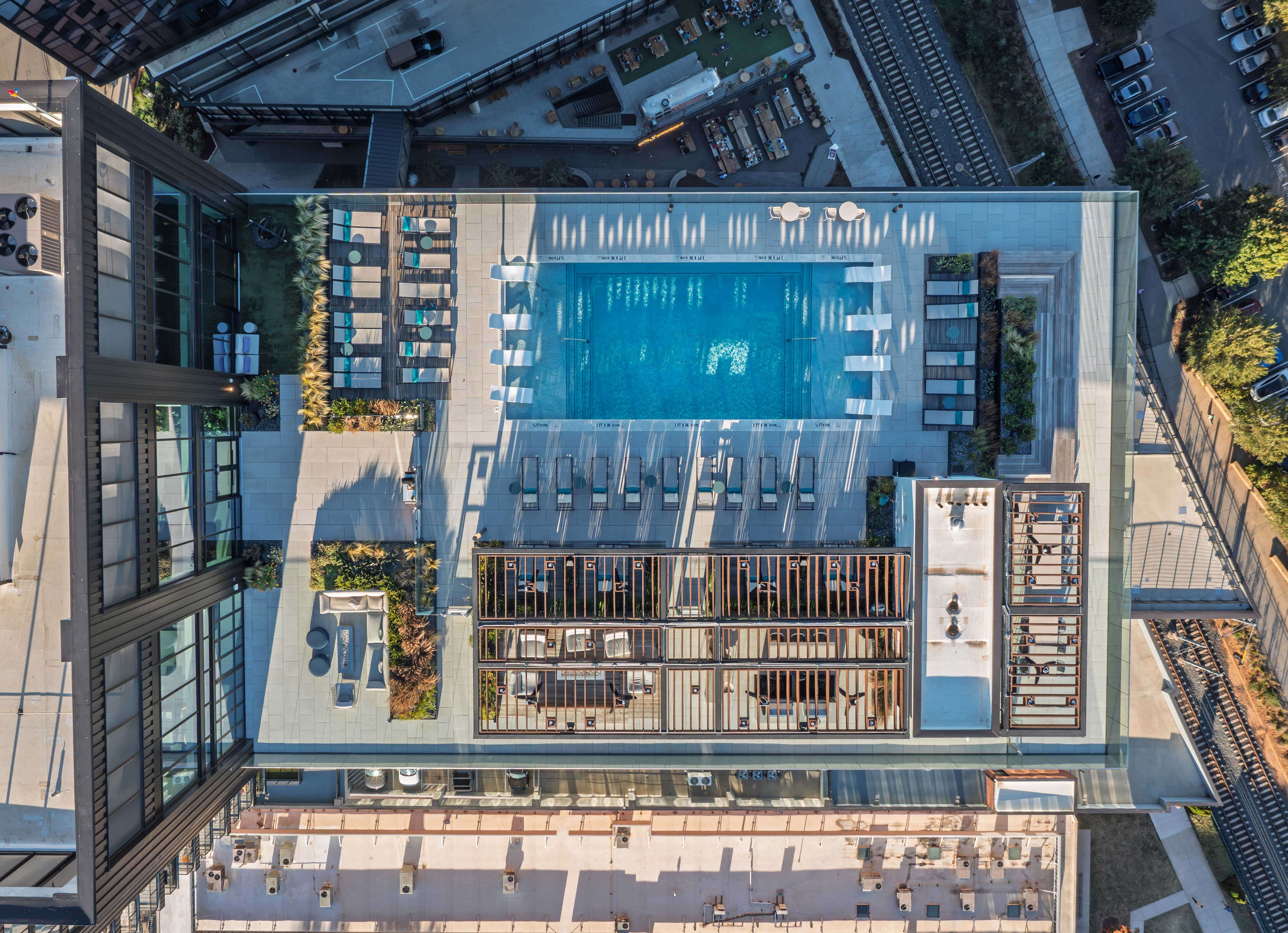 Perched on the 23rd floor, the rooftop terrace at Linea South End redefines outdoor living with a deck, fireplaces, and generous space for lounging in Charlotte, North Carolina.