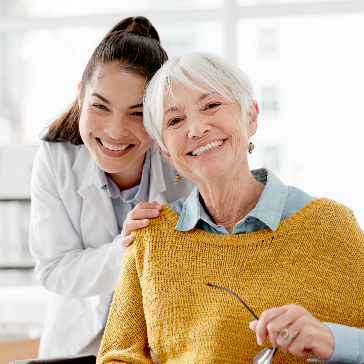 happy woman with dentures smiling and doing outdoor yoga
