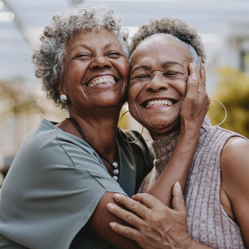 happy woman with dentures smiling and doing outdoor yoga