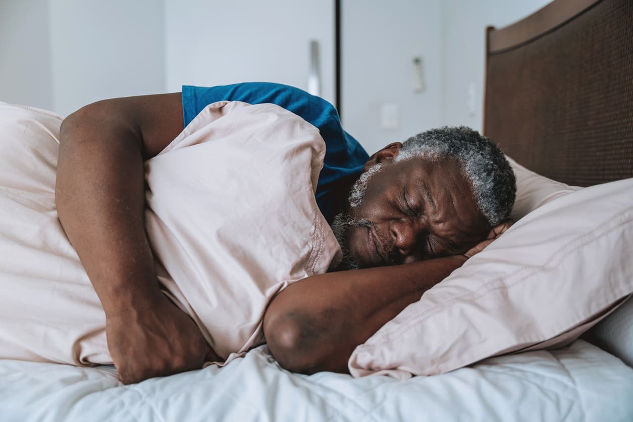 Older adult sleeping comfortably in bed after removing dentures for the night