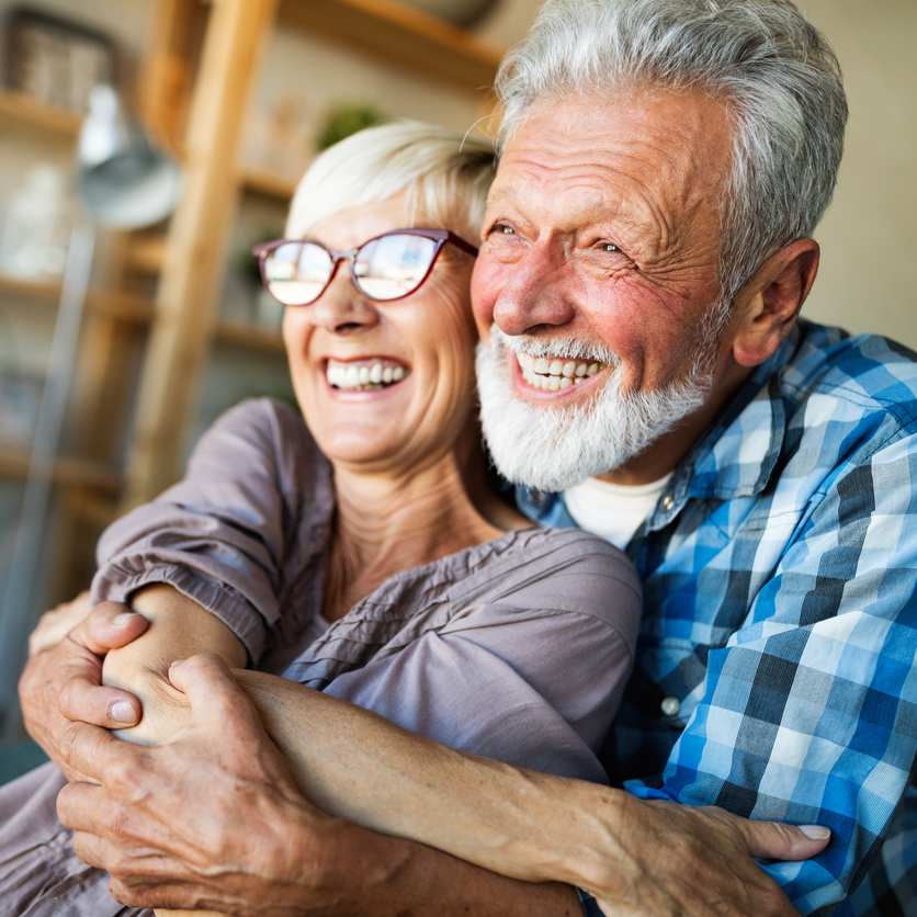 happy woman with dentures smiling and doing outdoor yoga