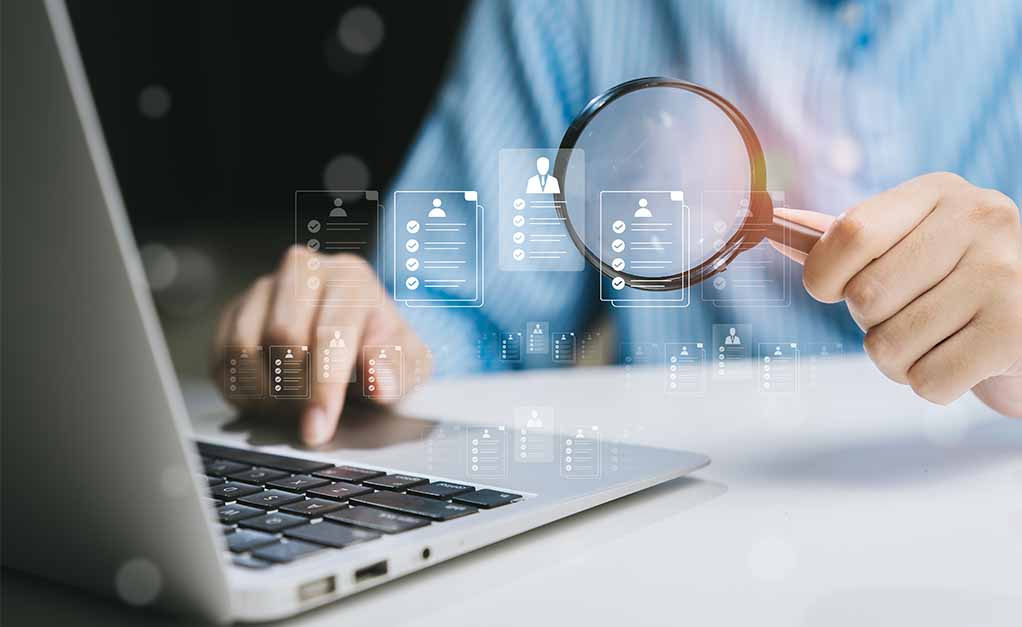 Magnifying glass hovering over laptop keyboard