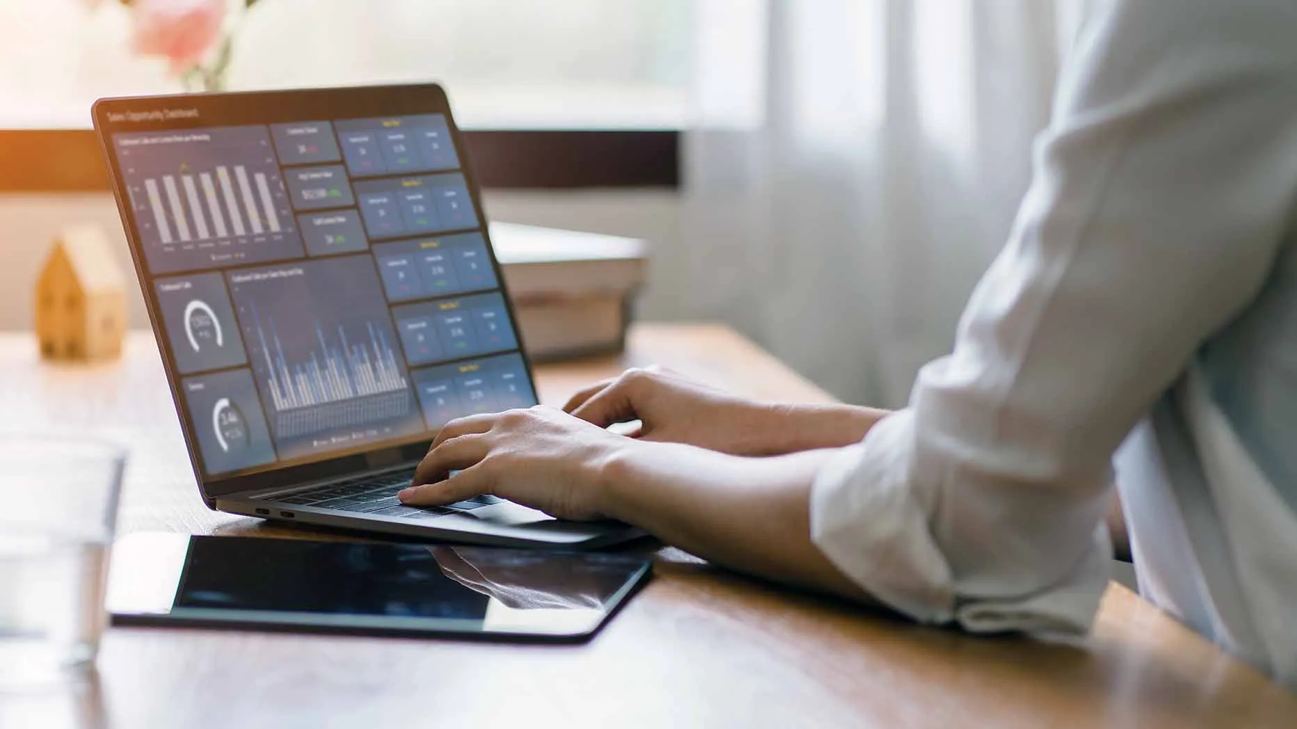 ACO leader examining data analytics dashboard on laptop