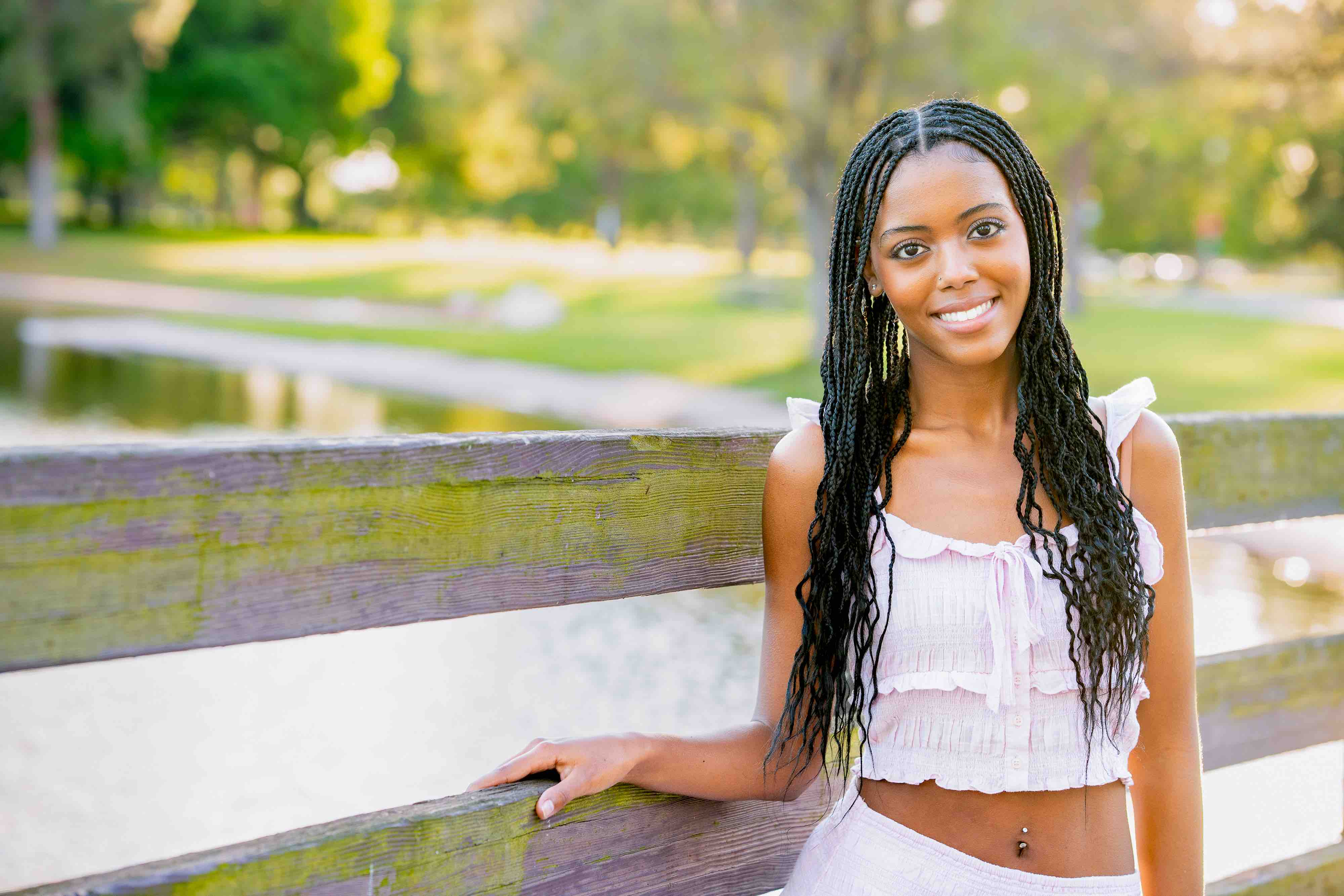 horizontal senior photo of a girl on a bridge