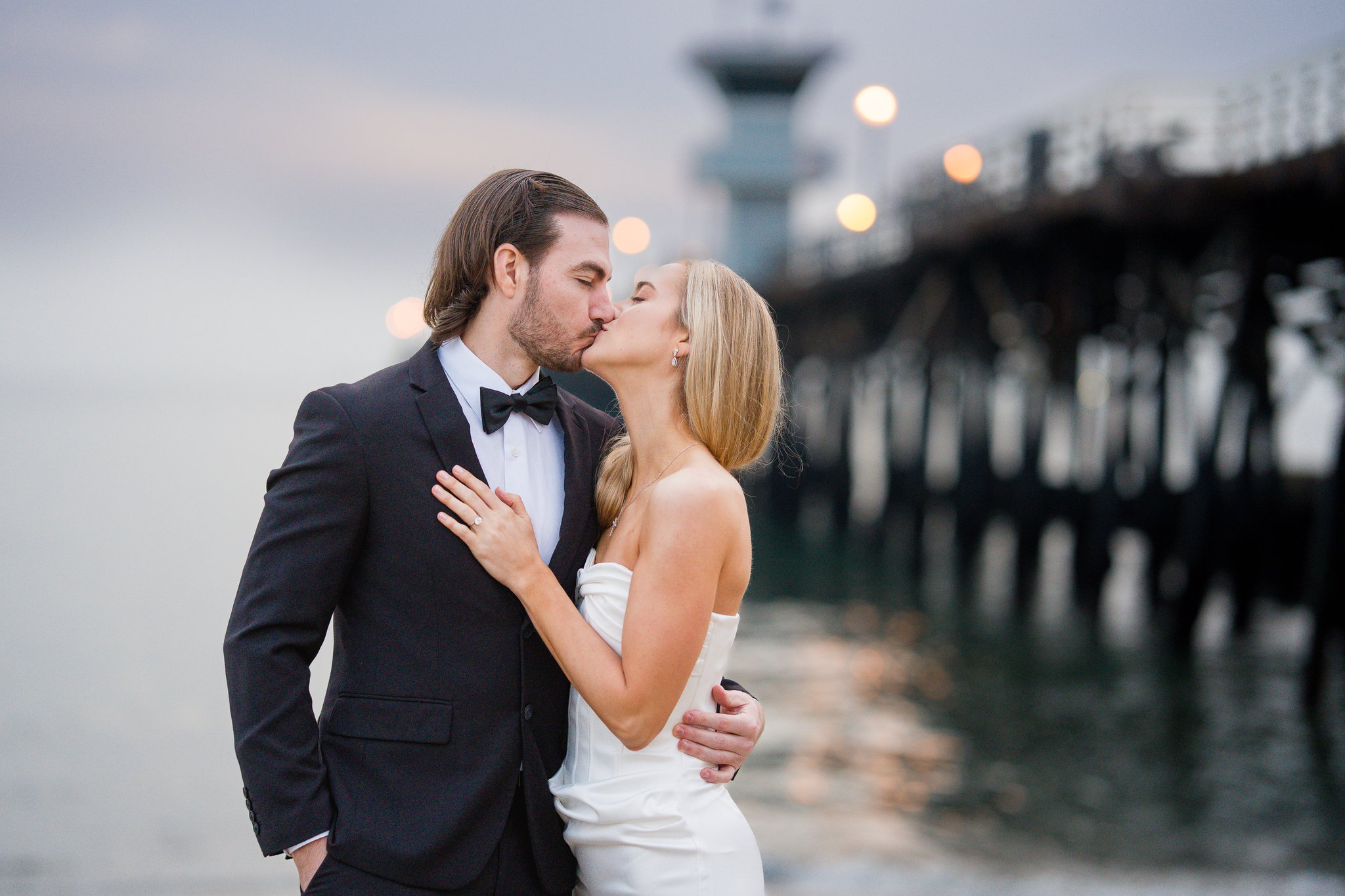 romantic and formal sunset engagement kiss at seal beach pier