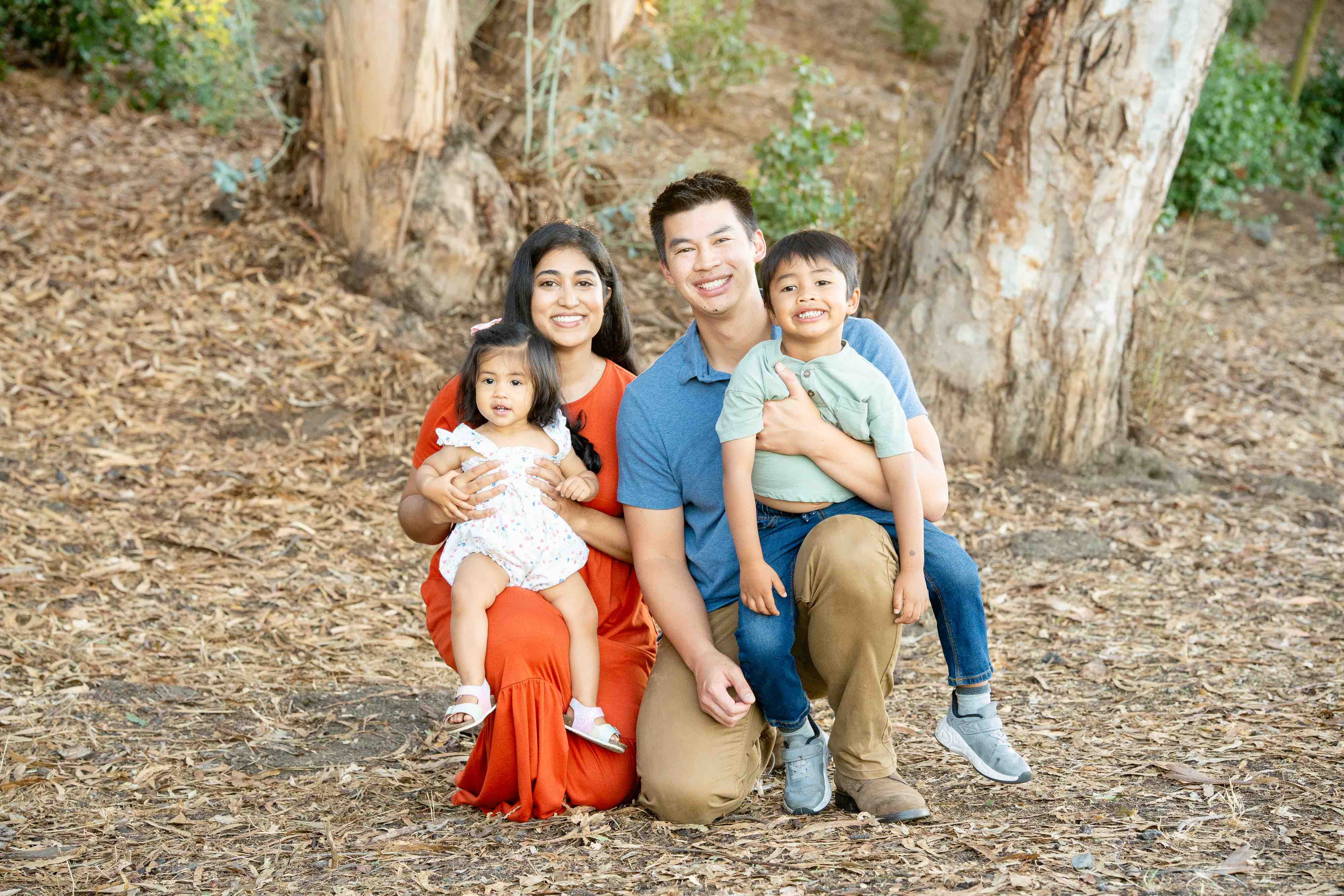 fall family photo at gum grove park in seal beach, colors of burnt orange and blue
