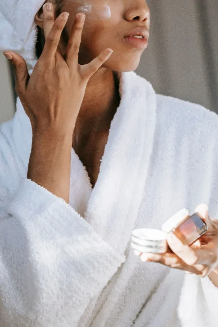 Creator applying skincare product on camera