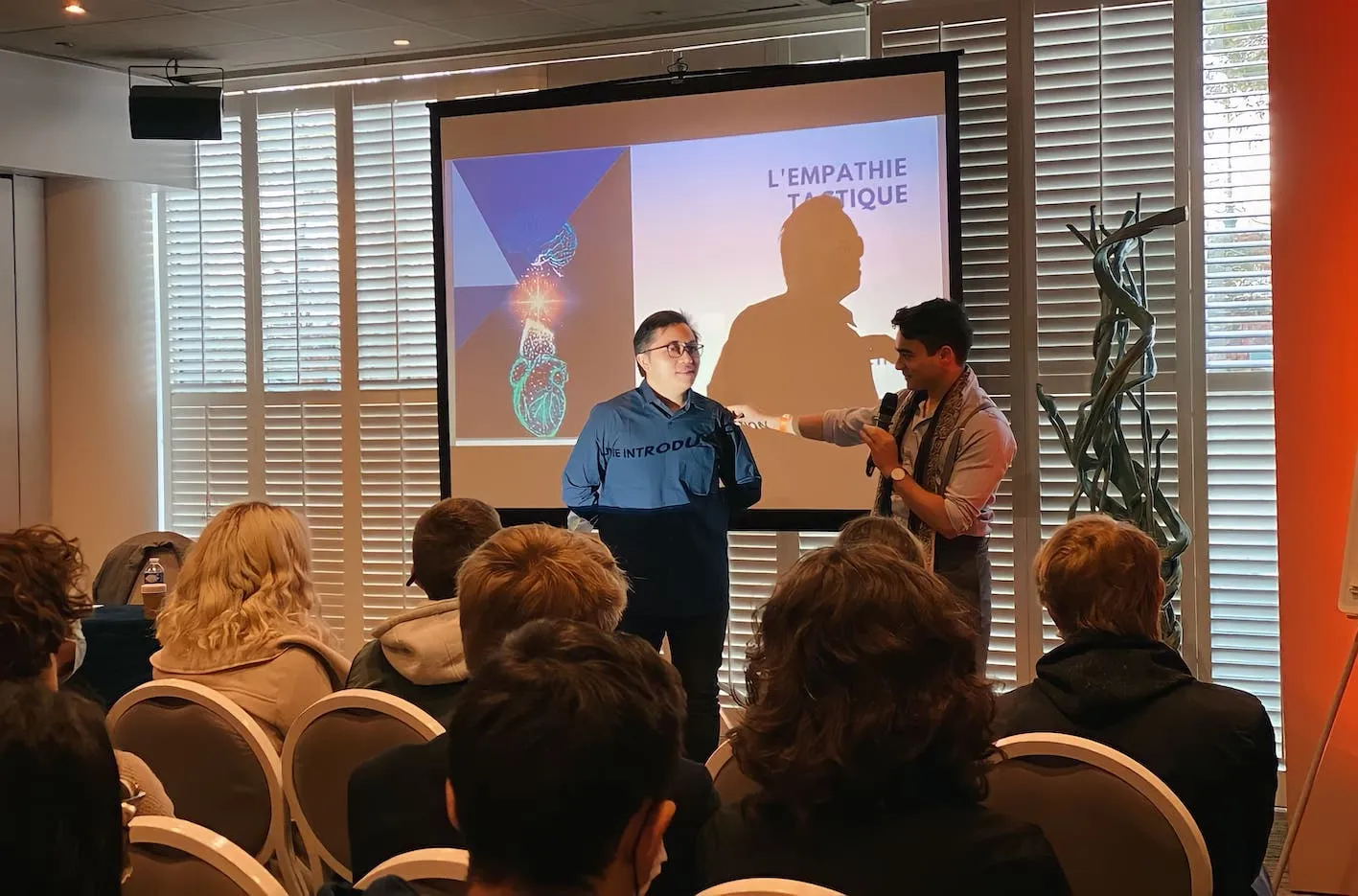 A Parisian magician captivating a corporate audience with breathtaking magic and mentalism at a sophisticated event.