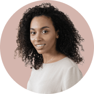 Portrait of a woman with curly hair wearing a light-colored top against a muted pink circular background.