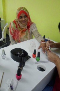 Women getting her nails painted.