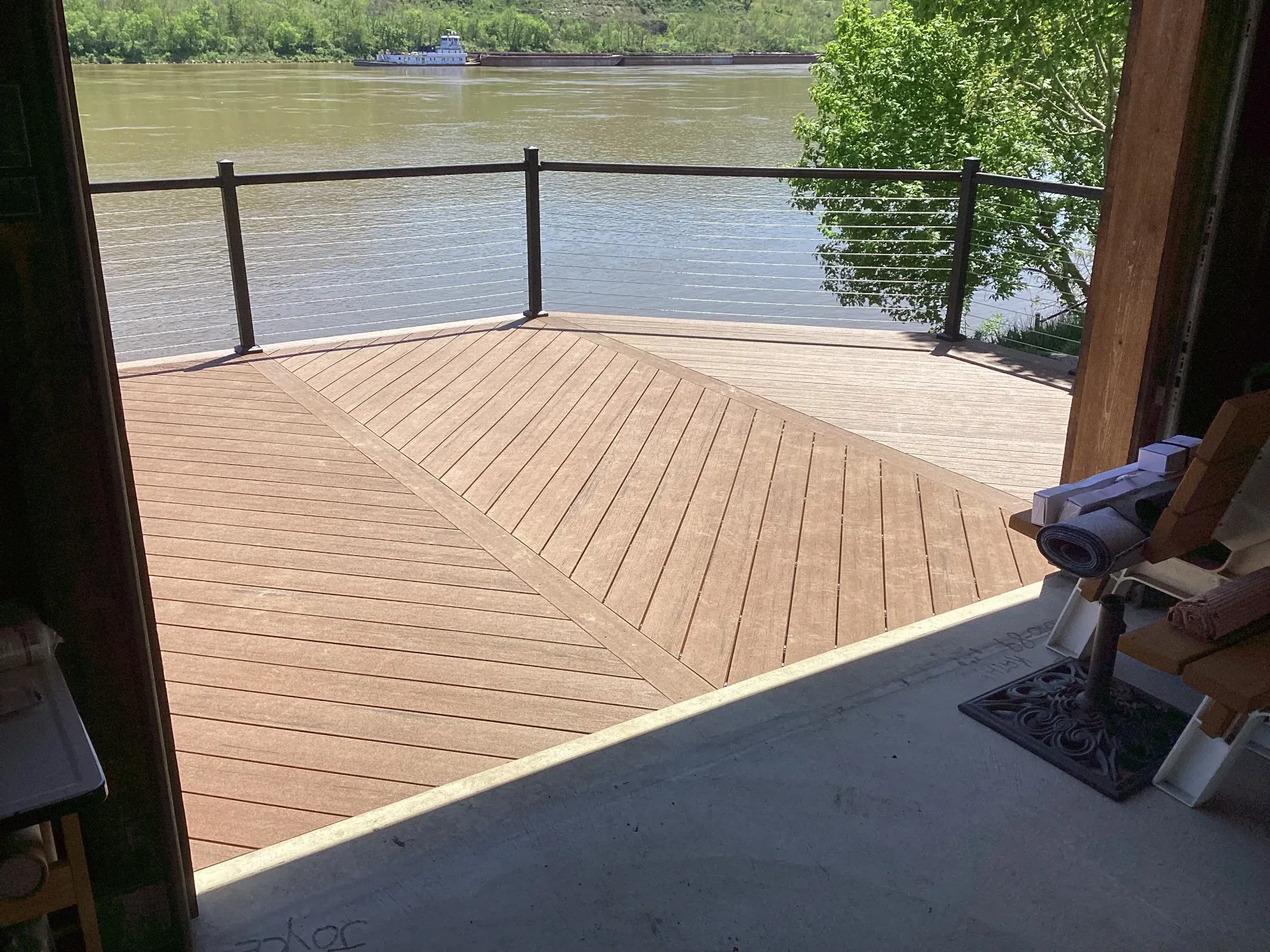 composite decking with wire railing on edge of water