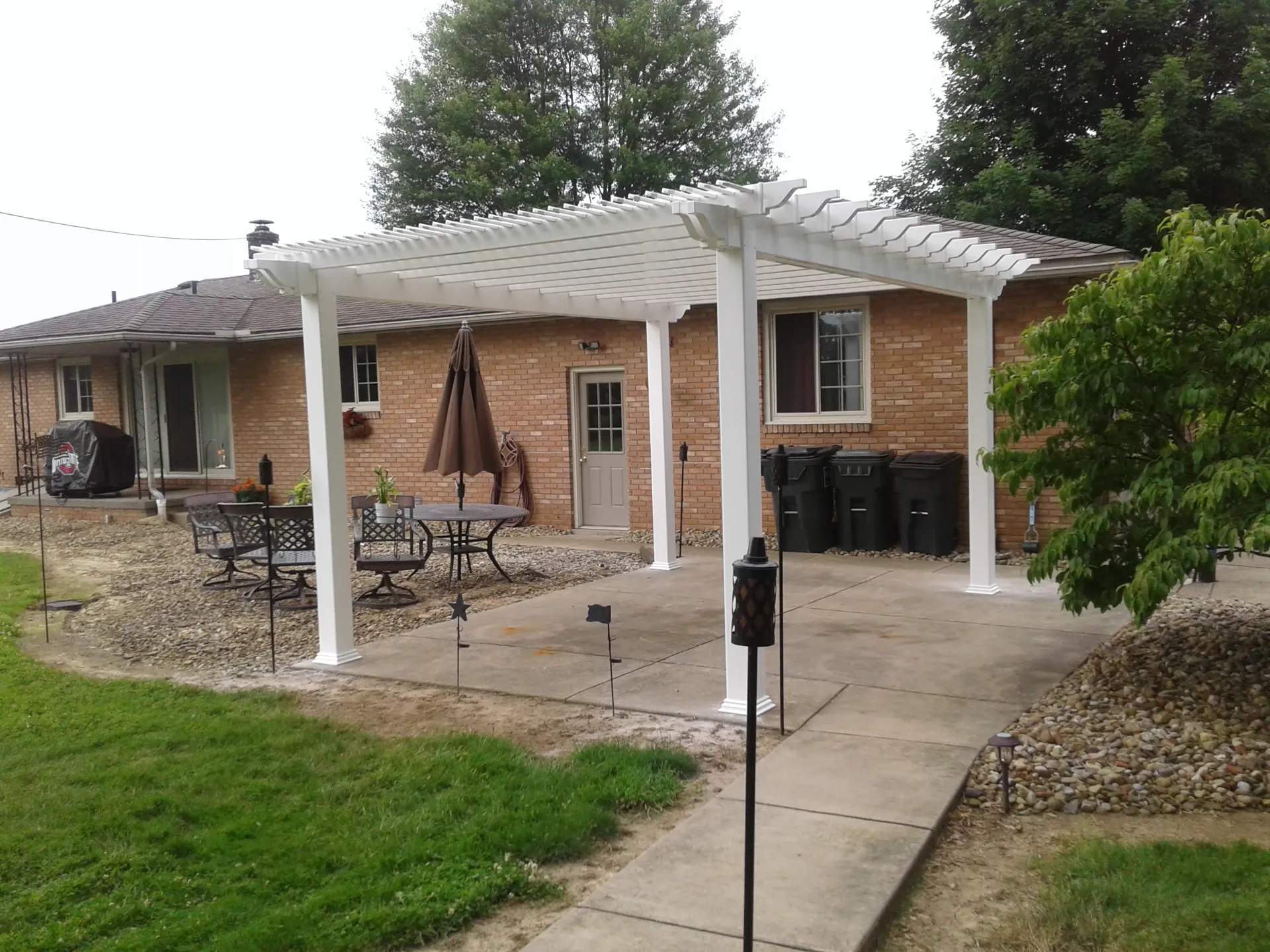 white vinyl pergola over concrete patio