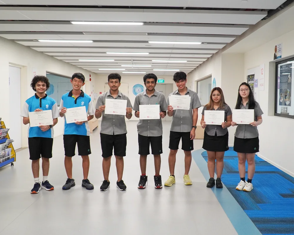 Nexus International School students holding certificates