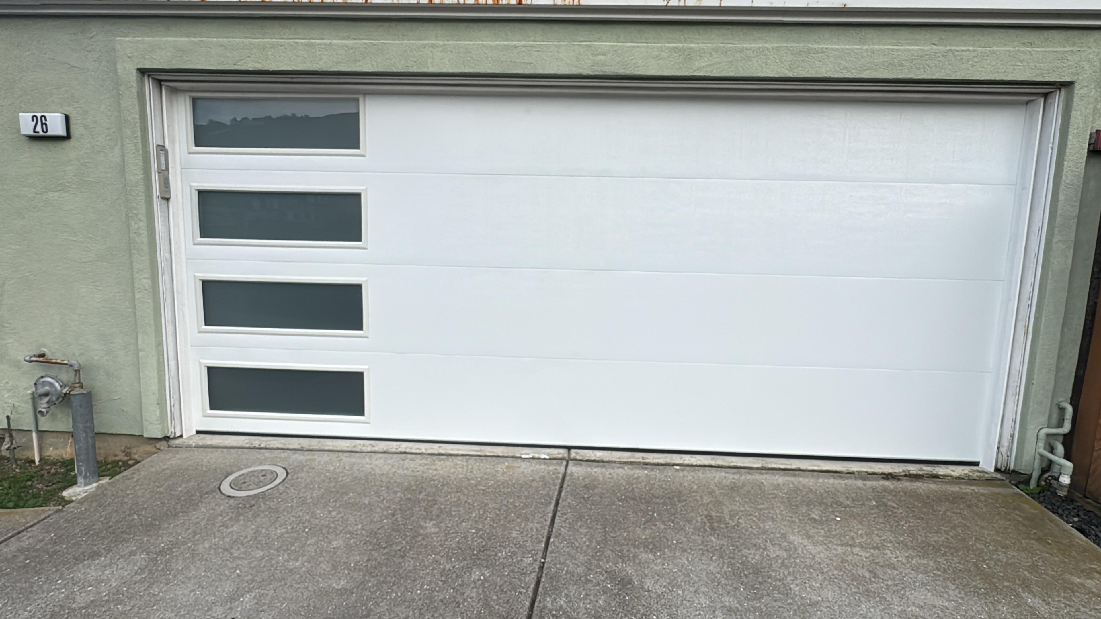 A white garage door with window panels